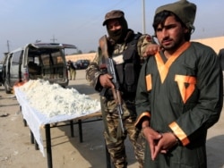 FILE - A captured Taliban insurgent is presented to the media after he was detained with car explosive devices in Jalalabad, Afghanistan, Dec. 10, 2019.
