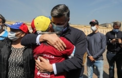 FILE - Venezuelan opposition politician Leopoldo Lopez embraces a person after participating in a popular consultation launched by opposition leader Juan Guaido to decline Venezuela's Dec. 6 parliamentary election, in Bogota, Colombia Dec. 12, 2020.