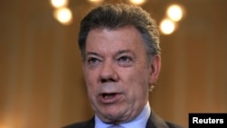 FILE - Colombia's President Juan Manuel Santos speaks at the presidential palace in Bogota, April 7, 2015. 