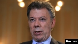 FILE - Colombia's President Juan Manuel Santos speaks during a Reuters interview at the presidential palace in Bogota, April 7, 2015. 