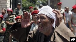 An Egyptian mourns outside the mosque at the funeral of 16 soldiers killed in an attack over the weekend by suspected militants in Sinai in Cairo, Egypt, August 7, 2012