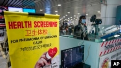 Pedestrians wear protective masks in Tokyo after Japan's government said a man treated for pneumonia after returning from China has tested positive for the new coronavirus identified as a possible cause of an outbreak in Wuhan, China. Jan. 16, 2020.