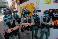 Police officers stand guard as people gather during a pro-democracy rally supporting human rights and to protest against Beijing's national security law in Hong Kong, June 28, 2020.