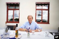 Göran Amnegård, owner of Blaxsta wine, smiles during wine testing in Flen, Sweden, Sunday, July 23, 2023. Amnegård planted his first vines over 20 years ago to launch a commercial vineyard. (AP Photo/Pavel Golovkin)