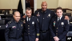 In this July 27, 2021 photo, from left, U.S. Capitol Police Sgt. Aquilino Gonell, Washington Metro Police Dept. officer Michael Fanone, U.S. Capitol Police Sgt. Harry Dunn and Washington Metro Police Dept. officer Daniel Hodges pose after a House hearing.