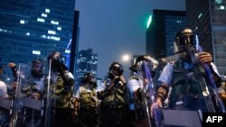 Riot police stand guard after a protest against a controversial extradition law proposal in Hong Kong on June 12, 2019.