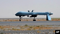 FILE - U.S. Predator unmanned drone armed with a missile stands on the tarmac of Kandahar military airport in Afghanistan. 