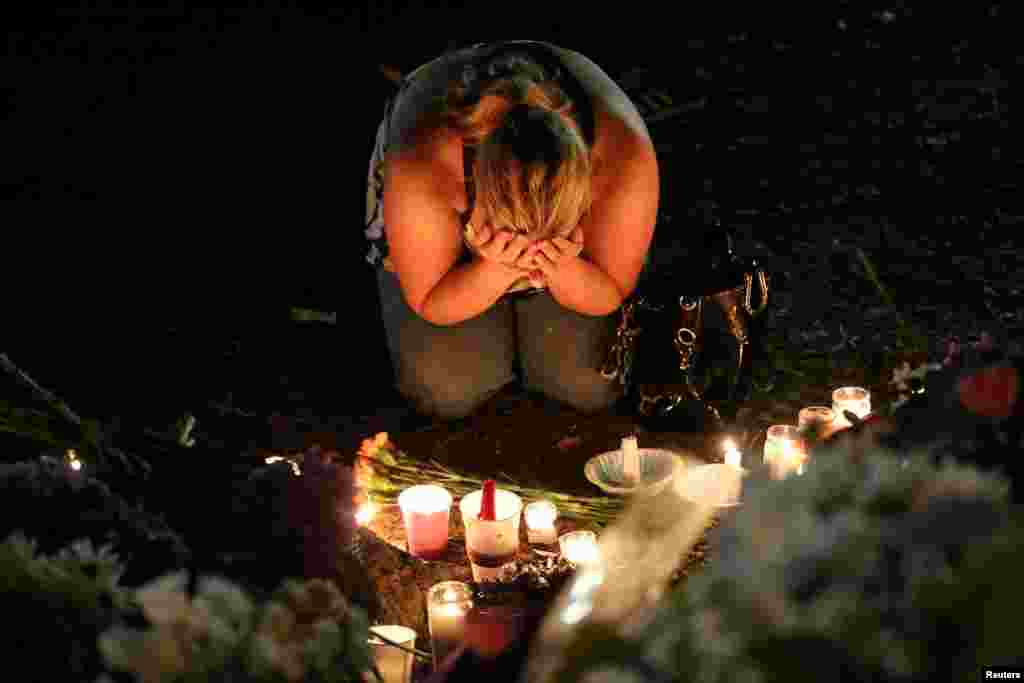 A woman mourns during a vigil for Pulse nightclub victims following last week's deadly shooting in Orlando, Florida, June 19, 2016.