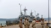 Sailors stand guard near petrol boats at the Cambodian Ream Naval Base in Sihanoukville, Cambodia, July 26, 2019.