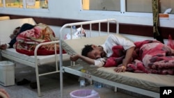 FILE - People are treated for suspected cholera infection at a hospital in Sanaa, Yemen, May. 15, 2017
