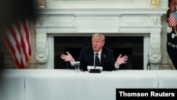 U.S. President Donald Trump talks about taking hydroxychloroquine at coronavirus response event with restaurant executives at White House in Washington, May 18, 2020.