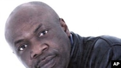 In this undated file photo provided by the militant group Movement for the Emancipation of the Niger Delta, militant leader Henry Okah poses for a photo. The ex-leader of a militant group that claimed responsibility for a dual car bombing that killed 12 i