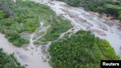 Orang-orang melintasi perbatasan antara Kolombia dan Venezuela, sebelum perbatasan dibuka kembali secara resmi, di Cucuta, Kolombia 25 September 2022. REUTERS/Leonardo Fernandez Viloria