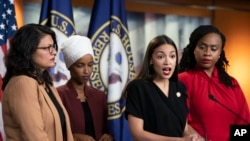 U.S. Rep. Alexandria Ocasio-Cortez, D-N.Y., speaks as, from left, Rep. Rashida Tlaib, D-Mich., Rep. Ilhan Omar, D-Minn., and Rep. Ayanna Pressley, D-Mass., listen during a news conference at the Capitol in Washington, July 15, 2019.