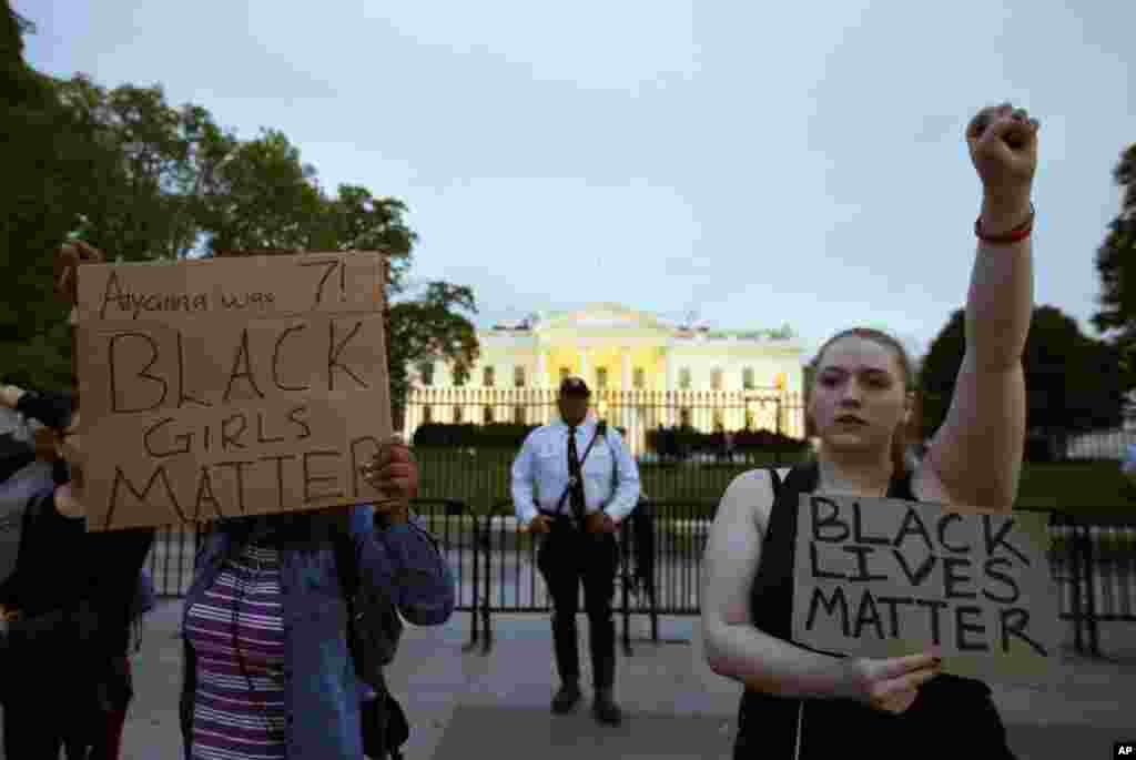Protestors hold signs&nbsp;in front of the White House during a protest to support the rallies in Baltimore, April 29, 2015.
