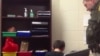 A screengrab from the video showing officer Kevin Sumner handcuffing one of the students.