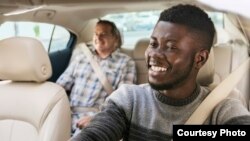 FILE - A passenger gets a ride from an Uber driver in South Africa.