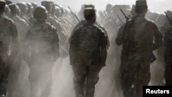 FILE - Afghan National Army (ANA) officers march during a training exercise at the Kabul Military Training Centre in Afghanistan, Oct. 7, 2015. 
