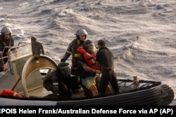 Australian Navy sailors from HMAS Choules used an inflatable boat to rescue Lithuanian rower Aurimas Mockus, second right, Monday, March 3, 2025
