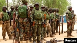 Soldiers stand during a parade in Baga village on the outskirts of Maiduguri, in the north-eastern state of Borno, Nigeria, May 13, 2013.