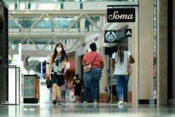 Shoppers walk through The Woodlands Mall in Texas, May 5, 2020. The mall reopened Tuesday with increased health and safety measures in place.