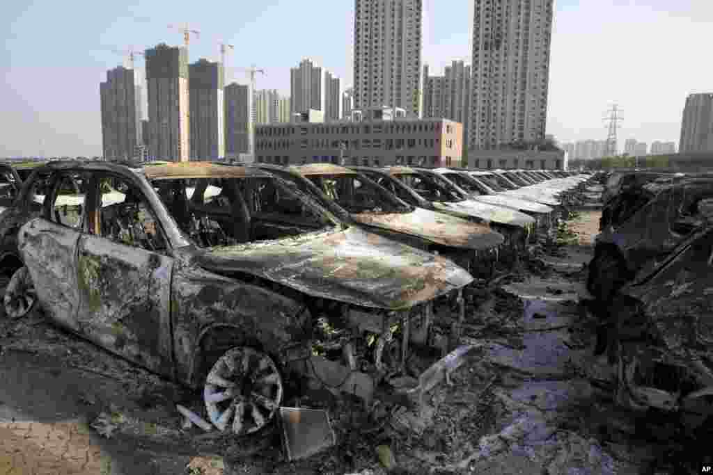 Charred remains of what were new cars after an explosion tore through the parking lot of a warehouse in northeastern China's Tianjin municipality, Aug. 13, 2015.