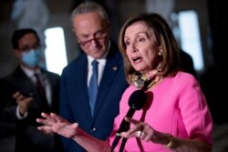 FILE - House Speaker Nancy Pelosi, accompanied by Senate Minority Leader Sen. Chuck Schumer, left, speak to reporters in Washington, Aug. 7, 2020.