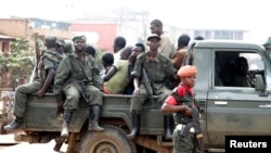 FILE - Congolese soldiers are seen on a pick-up truck after dispersing civilians protesting against what they say is the government's failure to stop killings and inter-ethnic tensions in the town of Butembo, North Kivu province, DRC, Aug. 24, 2016.