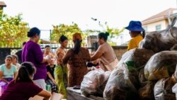 FILE - People queue up to receive food donations in a camp for displaced people in Namkham township in Shan state, Myanmar, June 7, 2021.
