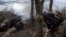 A Ukrainian serviceman of the Khartia brigade fires an M101 Howitzer toward Russian positions in Ukraine's Kharkiv region, March 12, 2025.