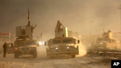 An Iraqi military convoy advances toward the city of Mosul, Iraq, Oct. 19, 2016. 