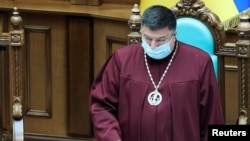 FILE - Oleksandr Tupytskyi, head of the Constitutional Court of Ukraine, presides over a court session in Kyiv, Ukraine, June 23, 2020. 