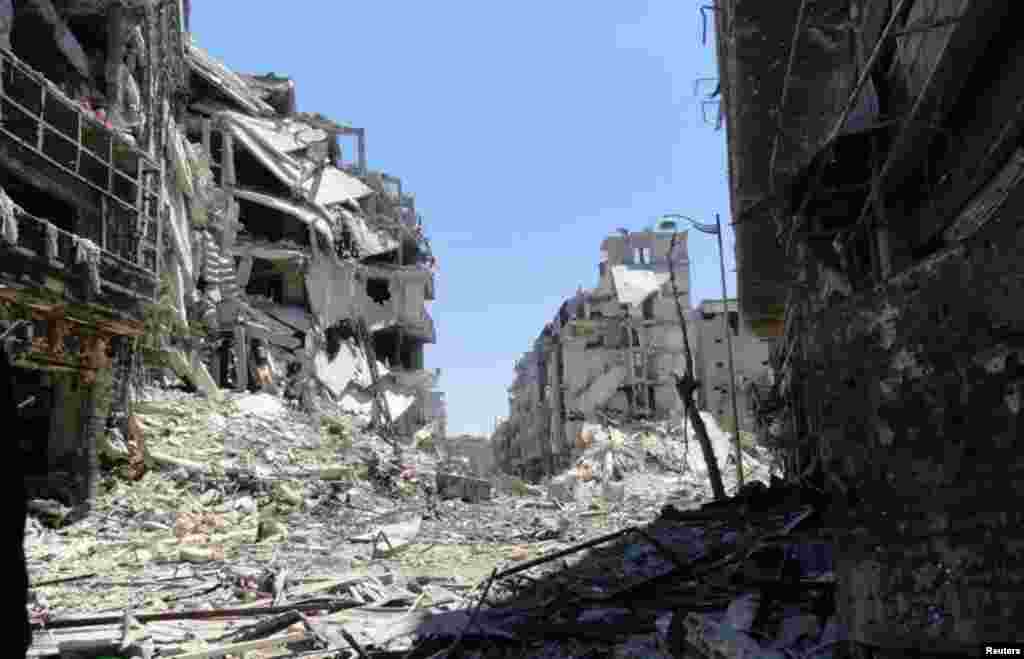 Damaged buildings are seen in Juret al-Shayah in Homs, Syria, July 27, 2012. 