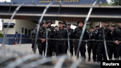 Guatemalan security forces keep watch at the Agua Caliente border with Honduras as part of Guatemala's measures to prevent Honduran migrants from crossing its territory toward the Mexican border, in Agua Caliente, Guatemala, Oct. 23, 2018. 