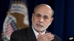 Federal Reserve Chairman Ben Bernanke gestures as he speaks during a news conference at the Federal Reserve Board in Washington, December 12, 2012.