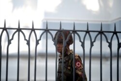 A Myanmar soldier looks on as he stands inside city hall after soldiers occupied the building, in Yangon, Myanmar, Feb. 2, 2021.