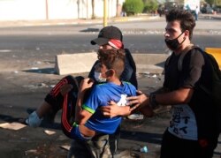 An injured protester is rushed to the hospital after being shot during a demonstration in Baghdad, Iraq, Oct. 4, 2019.
