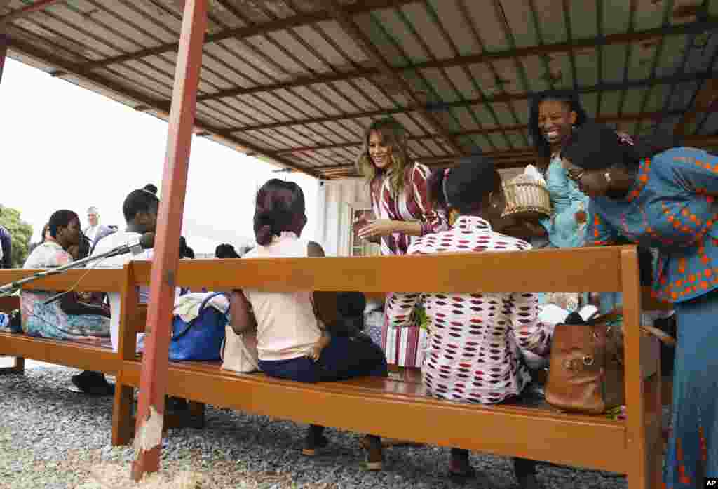 First lady Melania Trump hands out teddy bears to mothers and their babies at the Greater Accra Regional Hospital in Accra, Ghana, Oct. 2, 2018. 