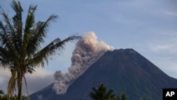 Mount Merapi releases volcanic materials down its slope during an eruption in Sleman, Indonesia, March 27, 2021. 