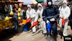 Petugas medis menyemprotkan disinfektan di pasar utama kota Gaza, di tengah pandemi Covid-19 di Jalur Gaza (foto: dok). 