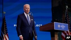 President-elect Joe Biden pauses as he leaves to listen to a reporter's shouted question at The Queen Theater in Wilmington, Del., Dec 22, 2020. 