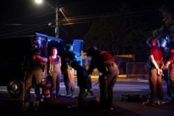 Police detain demonstrators on Sept. 5, 2020, the 100th consecutive night of protests against police violence and racial inequality, in Portland, Oregon.
