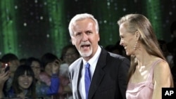 Film director James Cameron walks with his wife Suzy Amis on the red carpet during the opening ceremony of the second Beijing International Film Festival at the National Convention Center in Beijing, April 23, 2012.