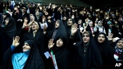 FILE - Veiled Iranian women attend a ceremony in support of the observance of the Islamic dress code for women, in Tehran, Iran, July 11, 2019.