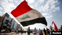 FILE - University students attend a protest against the U.S. and Iran interventions, in Basra, Iraq, January 8, 2020.
