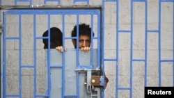 A patient looks from behind bars at a psychiatric hospital during a ceremony marking the World Mental Health Day in Sanaa, Yemen October 10, 2019. 