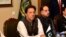 FILE - In this photo released by the Press Information Department, Pakistani Prime Minister Imran Khan, center, attends a briefing at the Foreign Ministry in Islamabad, Pakistan, Aug. 24, 2018. 