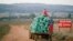 FILE - Farm workers harvest cabbages at a farm in Eikenhof, near Johannesburg, South Africa, May 21, 2018. 