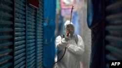 A worker wearing personal protective equipment disinfects the Merced Market in Mexico City on April 2, 2020. 