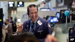 FILE - A trader is seen working on the floor of the New York Stock Exchange.